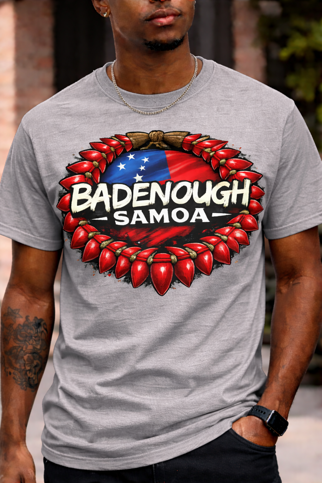Person wearing a gray t-shirt with 'Badenough Samoa' design featuring red chili peppers and a flag.